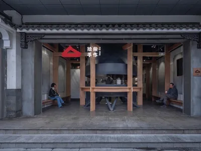 A modern Asian restaurant with a large dining table, chairs, and several people enjoying their meals in a stylish and inviting atmosphere