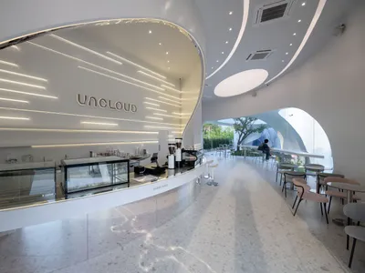 Bright and inviting open concept restaurant with multiple tables, chairs, and ample seating options