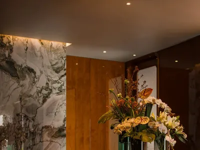 Elegant living space with a marble countertop, vases, and flowers, creating a sophisticated atmosphere