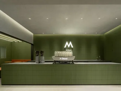 A casual coffee shop counter with cups, bottles, and a sink, set in a dining establishment with a relaxed atmosphere