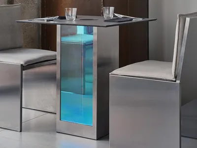 Modern dining area with a glass centerpiece, metal chairs, and a contemporary ambiance
