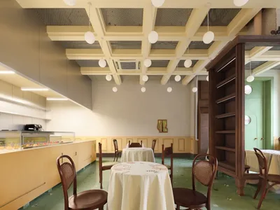 A dining area with a large table and chairs, a white tablecloth, and a cozy atmosphere