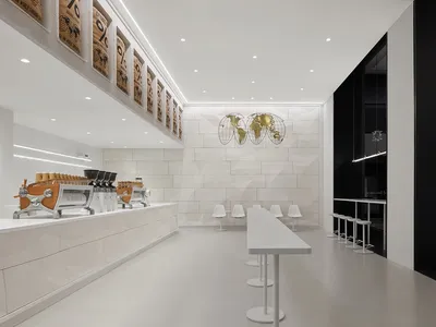 Empty restaurant interior with a large white countertop, chairs, and two dining tables in a clean and well-lit space