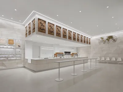 Open modern restaurant space with a large white countertop, chairs, and dining tables, with a focus on minimalistic design and functionality