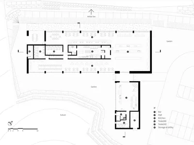 2D floor plan of a modern restaurant with dining and kitchen areas, featuring multiple tables, chairs, and sinks