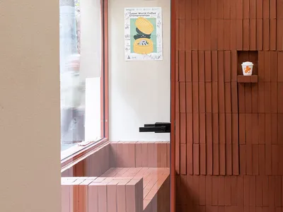 Cozy bathroom with a brick wall, a wooden bench, and two people in the scene