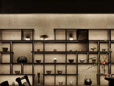 A showroom display of various bowls on shelves, arranged in a neat and visually appealing manner, creating an elegant and sophisticated atmosphere