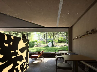 Modern restaurant interior with a dining area, bar counter, and comfortable seating for guests