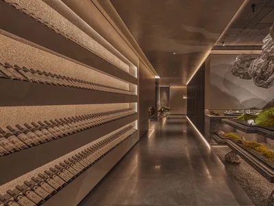 A sophisticated interior design showroom featuring a large display of wine bottles on shelves, creating an eye-catching presentation