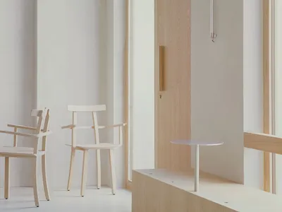 An inviting room with four wooden chairs and a small table, ideal for socializing or relaxation