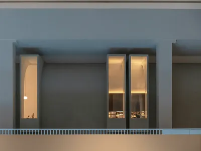 Empty room with two large windows on opposite walls, allowing natural light to enter and creating a bright atmosphere
