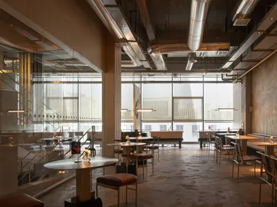 Modern restaurant interior with artwork, natural light, and ample seating options