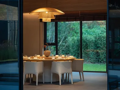 A modern dining space with a round table, white chairs, and various decorative items, creating a welcoming atmosphere