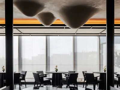 Cozy restaurant dining space with a round table and chairs, modern design, and good lighting