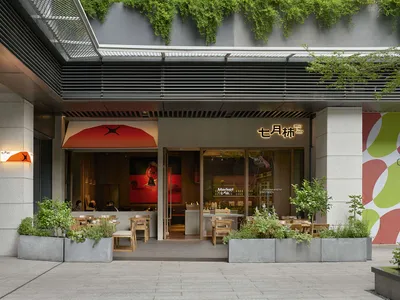 Modern Asian restaurant with a large window, wood and metal elements, and comfortable seating for dining