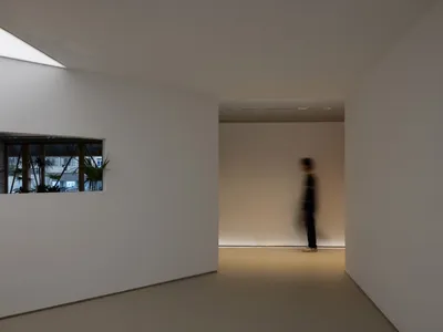 Empty hallway with white walls and floors, creating a clean and minimalist atmosphere