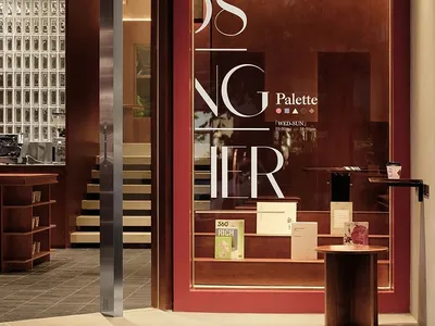 A storefront display featuring books, cups, and bottles arranged in an inviting and organized manner