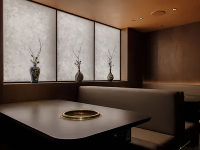 A modern restaurant with a brown color scheme, featuring multiple dining tables and chairs, creating a warm and inviting atmosphere
