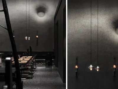 A restaurant interior with a warm atmosphere, featuring a long table, chairs, and modern lighting fixtures