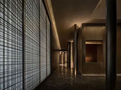 Empty hallway with a black marble floor and wood paneling walls, creating a calm and quiet atmosphere