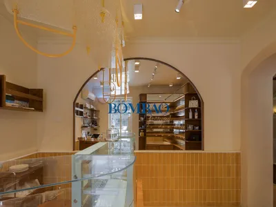 A yellow-themed store with bottles and bowls on display, offering a variety of products in a well-organized layout