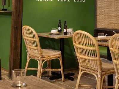 Cozy dining area with a table, chairs, green walls, and various items on the table