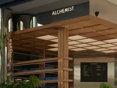 A well-organized retail space with wooden design, featuring bottles and cups on display, creating a warm and inviting atmosphere