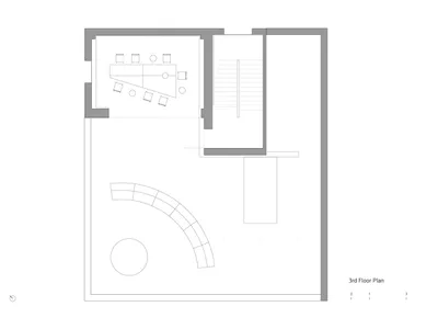 Empty minimalist living space with a circular window, chairs, and a dining table, featuring a clean and simple design