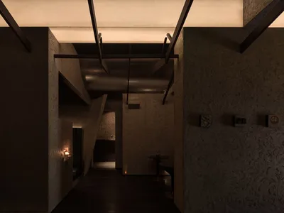 Empty modern hallway with white walls, wooden floors, two dining tables, and three chairs