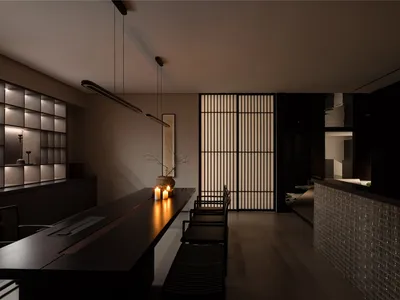 現代廚房與餐廳空間，配有黑色檯面、兩把椅子、盆栽與花瓶，營造舒適時尚氛圍