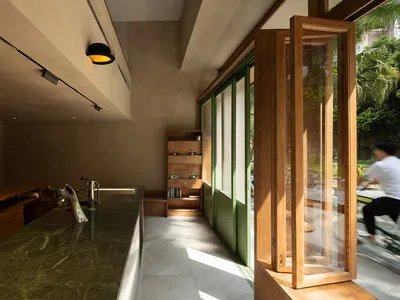 A warm and inviting kitchen with a bookshelf, sink, and doorway to the outdoors