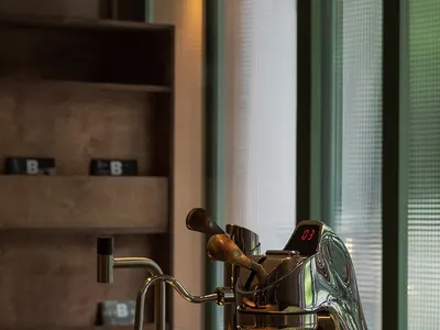 A well-organized kitchen area with a coffee maker, two cups, and a countertop
