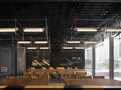 A modern restaurant dining area with multiple tables and chairs, creating a cozy atmosphere for guests