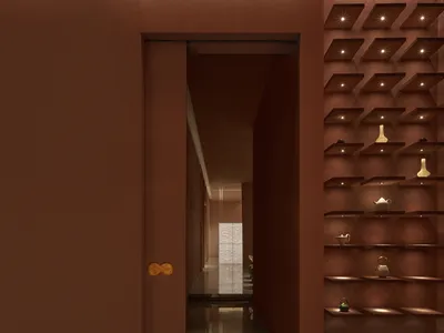 A warm and inviting hotel hallway with a red accent wall, brown door, and decorative vases on the walls