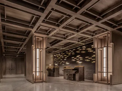 A hotel lobby with a large wooden structure, two lamps, and an elegant atmosphere