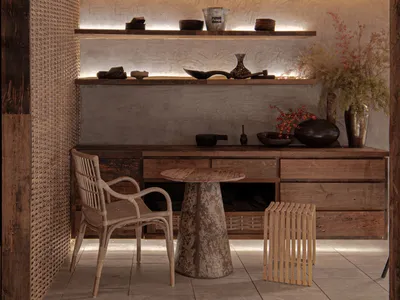 A well-lit living area with wooden floors, a dining table, chairs, and decorative vases and bowls, creating a warm and inviting atmosphere