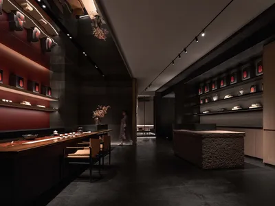 黑白主題餐廳，設有桌椅圍繞的用餐區、花瓶與石材地板，傳達優雅與親密的氛圍