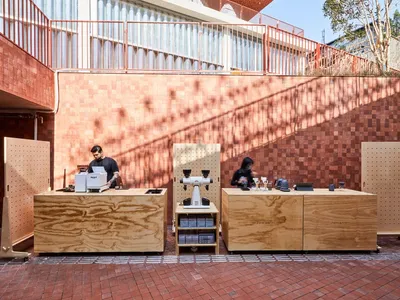 A casual dining area with a counter, chairs, and various items on display, suggesting a social gathering environment