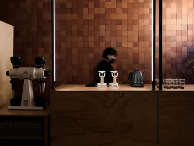 木質檯面上的咖啡壺，環繞著杯碗，井然有序的現代廚房展示氛圍