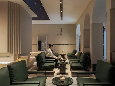 A spacious showroom with multiple chairs in various styles, arranged for customers to test comfort and appearance, in a welcoming and inviting atmosphere