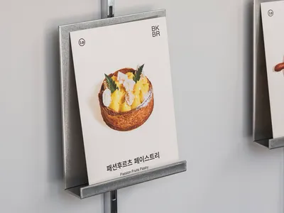 A display of food items in an Asian restaurant, with books on metal racks showcasing menu options