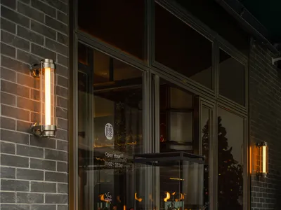 A modern living space with a metal fireplace, a bench, and warm atmosphere