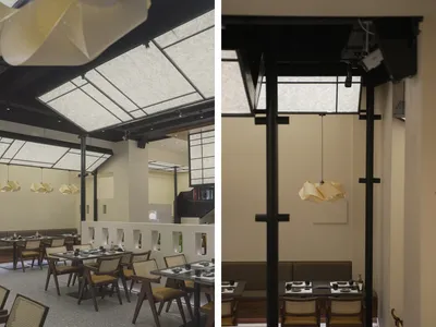 Empty modern restaurant interior with dining tables and chairs, a well-lit space with a focus on the ceiling design