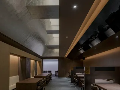 An inviting restaurant interior with wooden tables and chairs, providing ample seating options for guests in a warm and cozy atmosphere