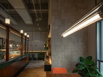 Inviting restaurant interior with tile walls, tables, chairs, and potted plants