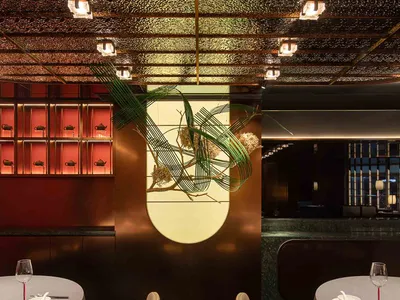 Elegant dining space with a large dome, chairs, and a dining table, set in a sophisticated environment