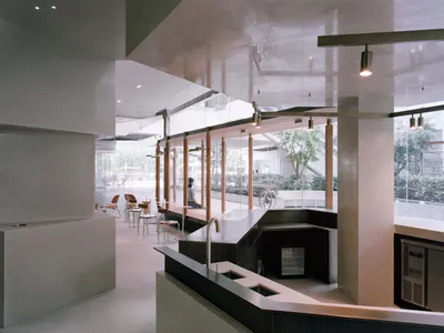 Modern restaurant interior with a large bar area, fireplace, and comfortable seating for guests
