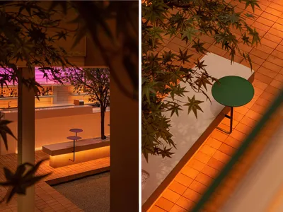 綠白桌椅與盆栽植物的餐廳內部，營造舒適的用餐氛圍