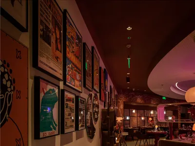 A well-lit interior design showroom with colorful posters on the walls, creating a visually appealing atmosphere