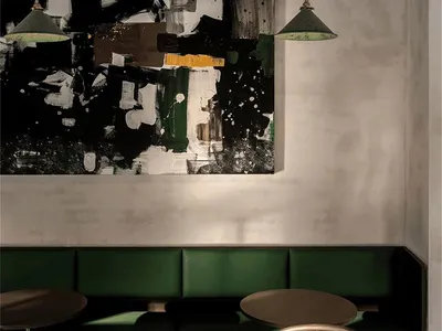 綠色長椅與餐桌營造舒適用餐氛圍的溫馨餐廳內部